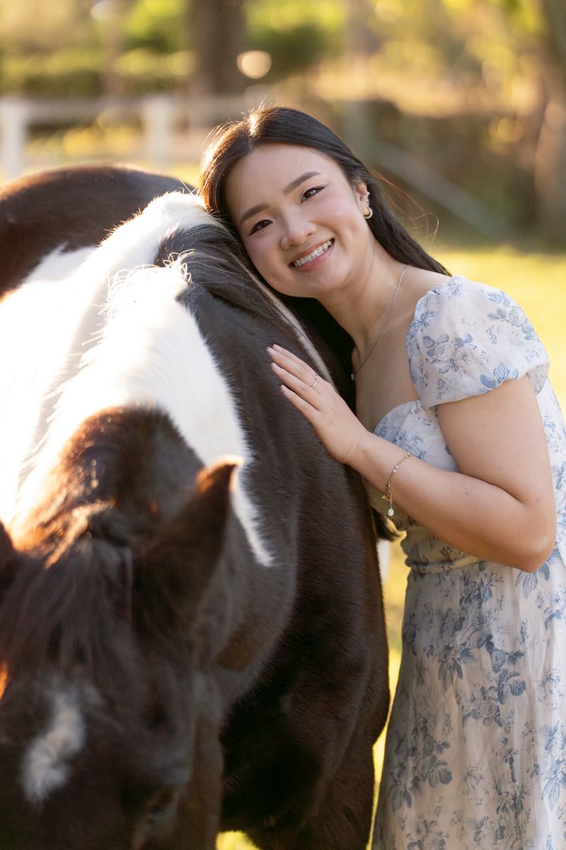 a girl met a horse for a photoshoot in Sydney and cuddled up to him. Stunning portrait photo by Hergott Photography