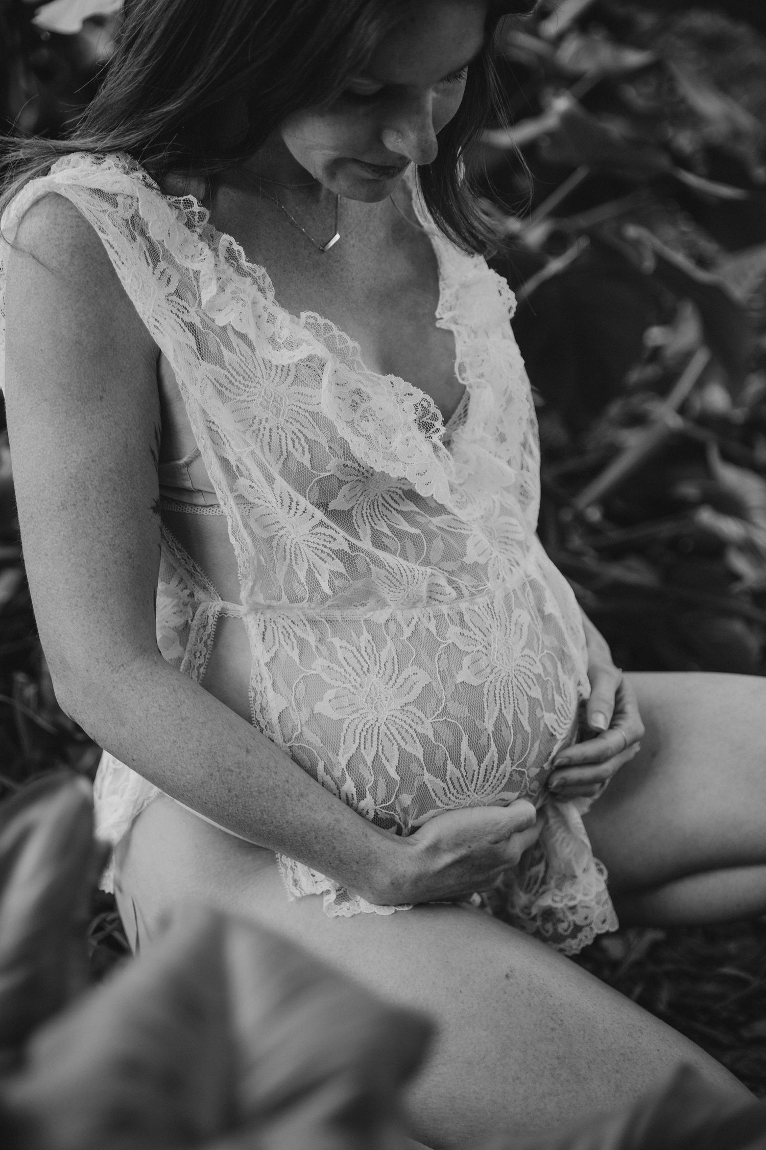 Black and white close-up of delicate lace fabric details.
