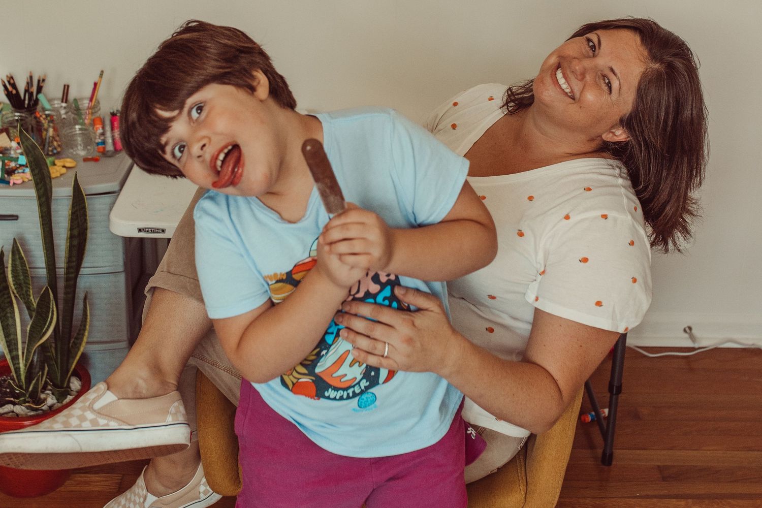 Mom and daughter playing together while daughter eats popsicle. WHITNEY POPP, Virginia