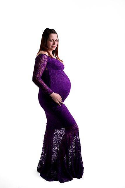 Elegant purple lace maternity gown with floor-length mermaid silhouette against white background.