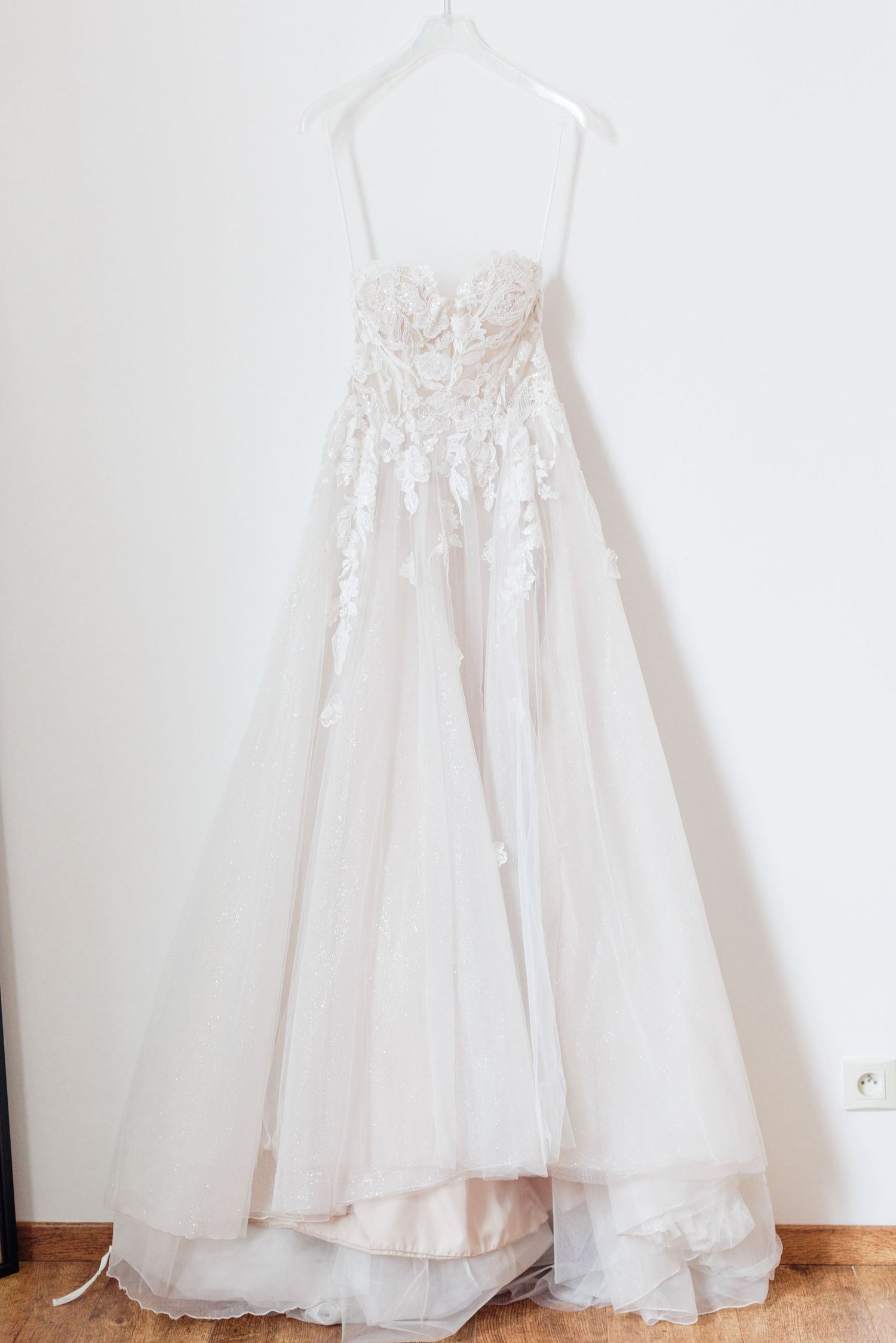 Elegant lace-detailed bridal gown in natural light during wedding preparations in the Lot region.