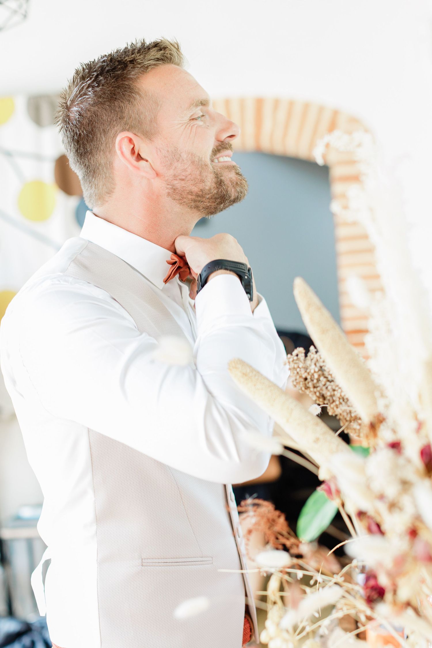 Groom Thomas adjusting his warm-toned suit before the civil ceremony in Montauban.