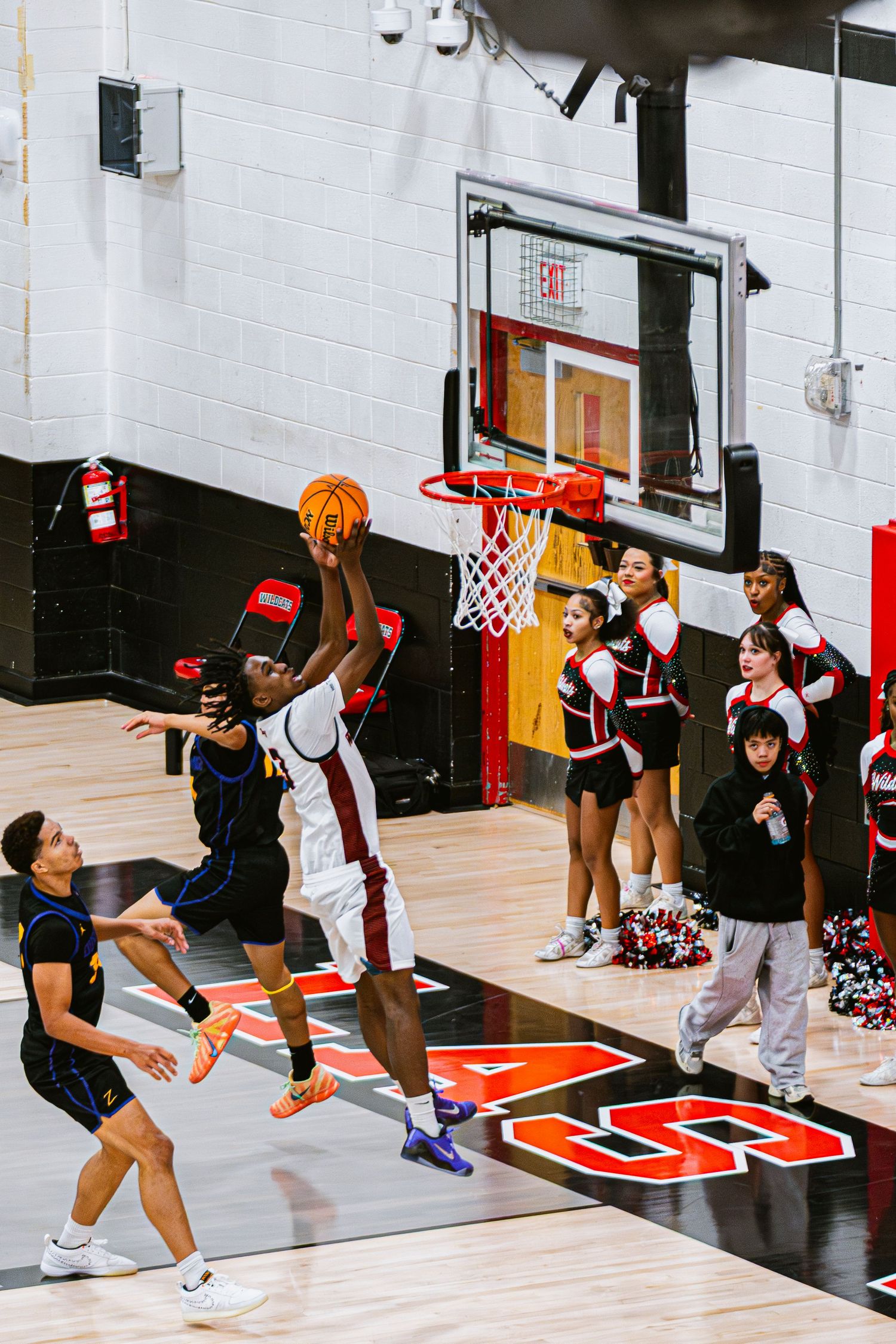 Mens Basketball Player jumping up to dunk