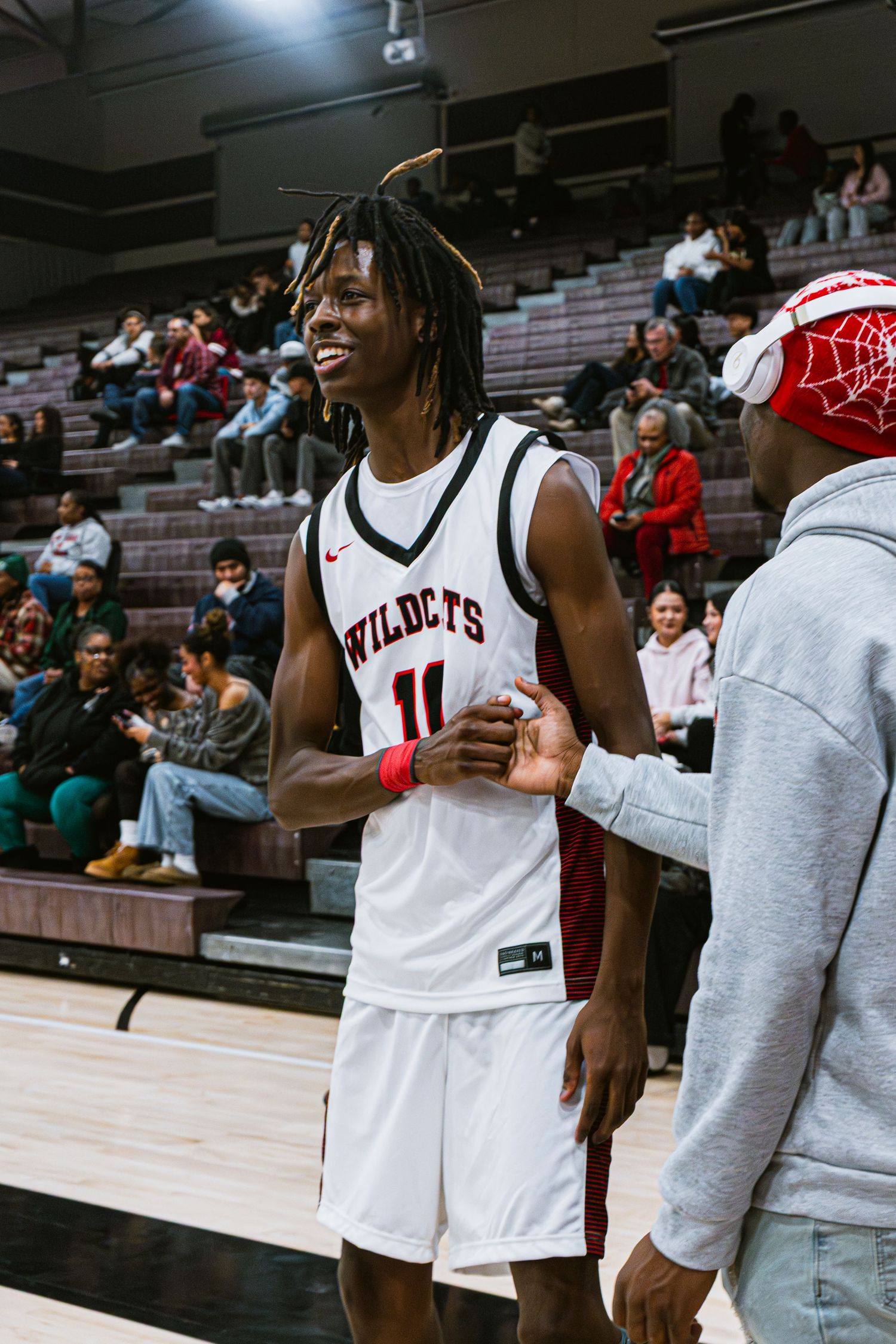 Mens Basketball Player high giving a friend