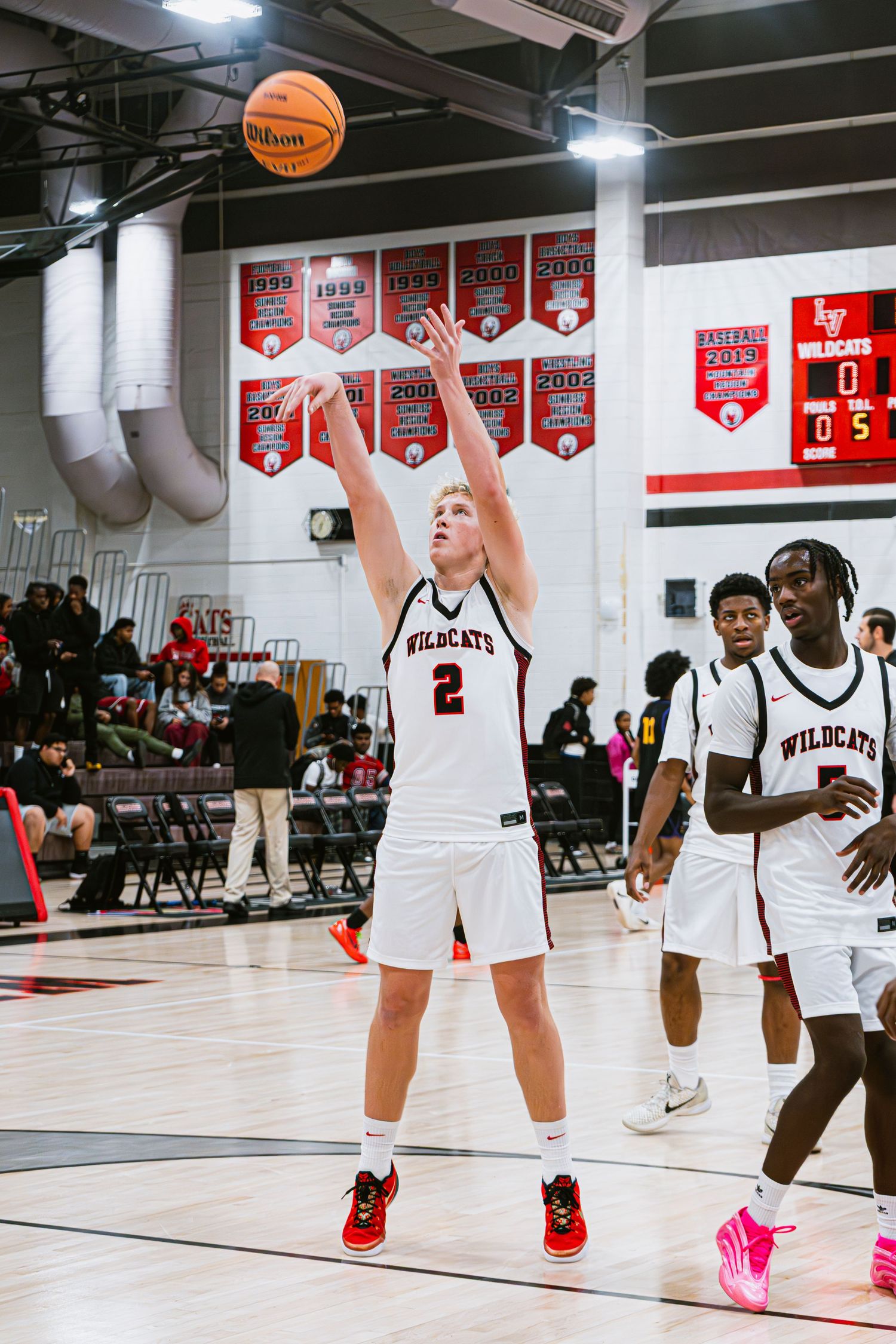 Mens Basketball Player shooting a three point shot