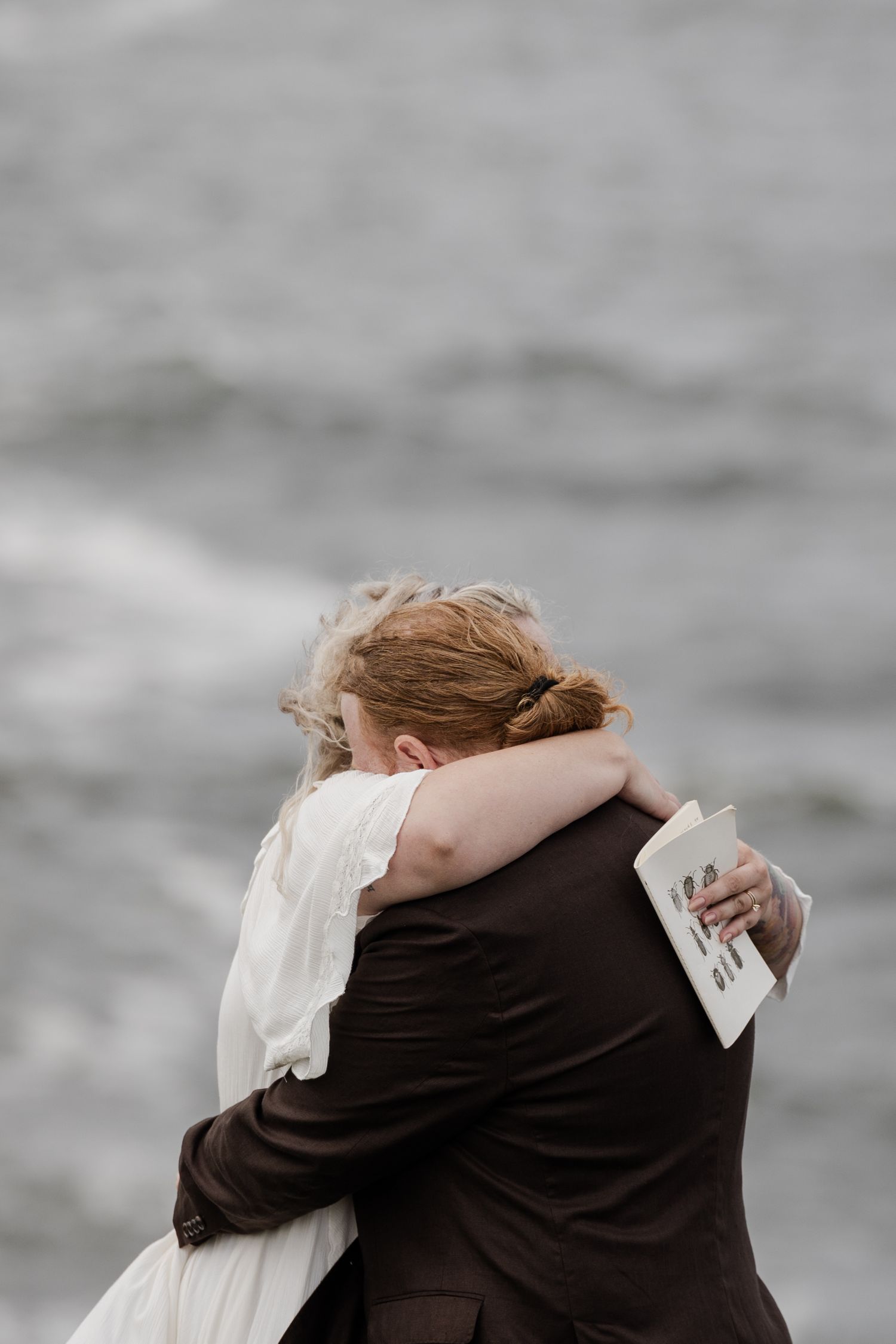 Couple sharing private promises during emotional Ireland cliffside wedding ceremony