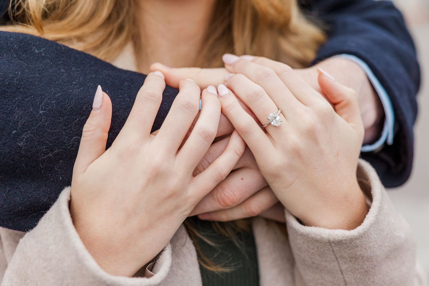 Close-up view of hands holding each other in a supportive and comforting gesture.