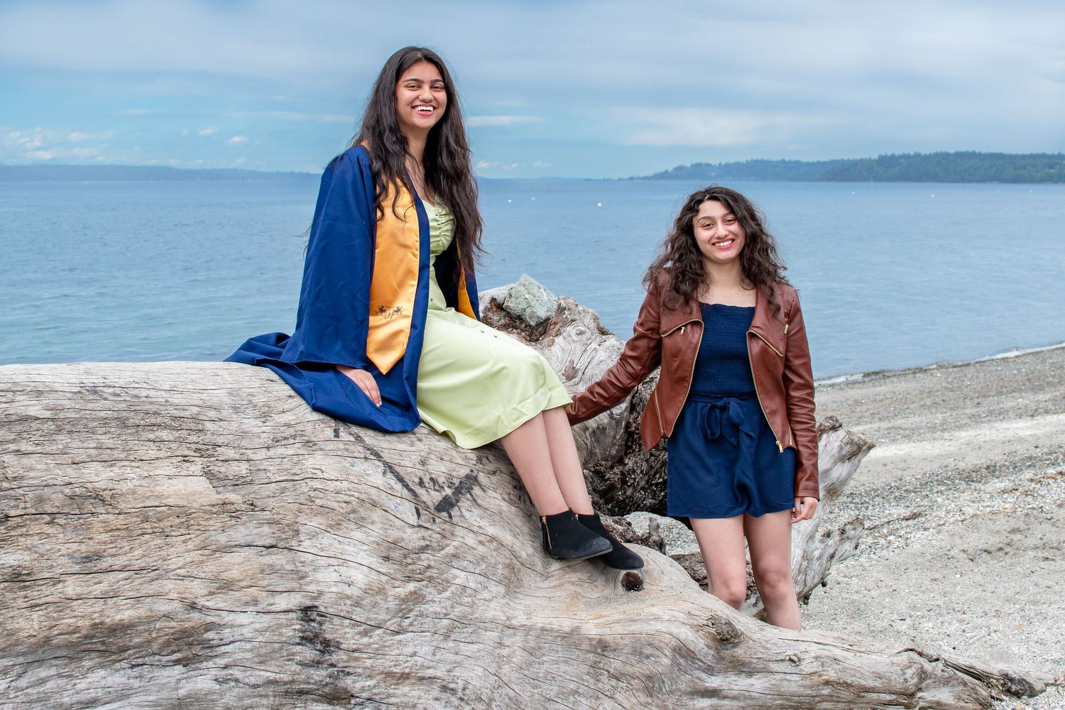 Senior high school graduate posing with her sister during a graduation photo session in Seattle