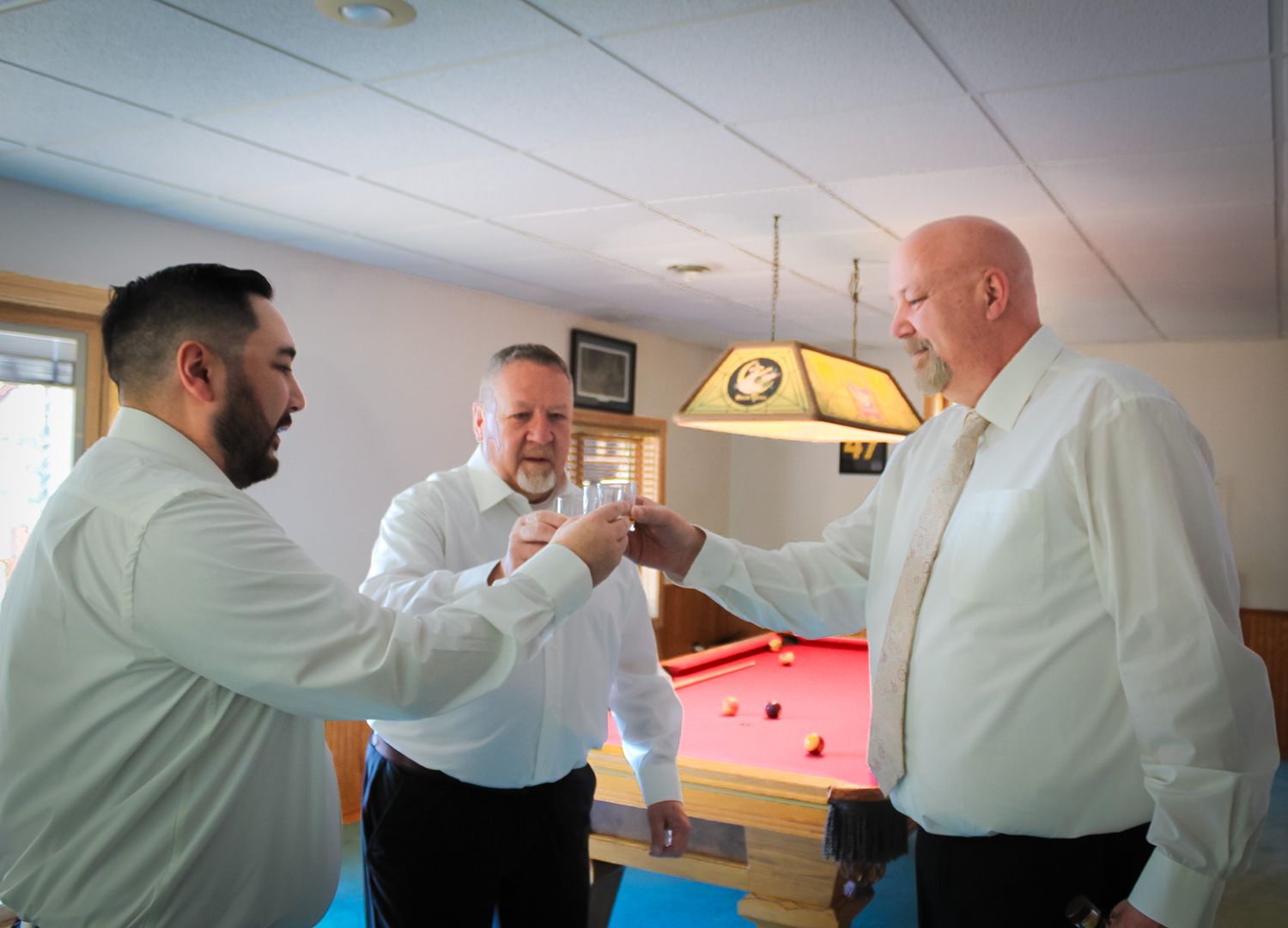 Two people in white uniforms demonstrate martial arts self-defense techniques in a training facility.