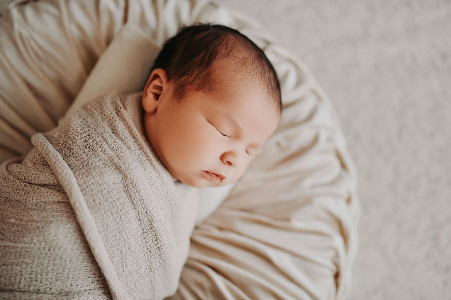 Peaceful newborn baby photographed naturally