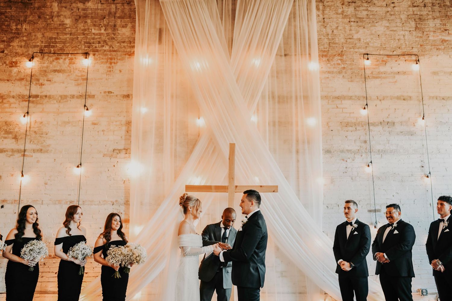 Groom waiting at altar as bride approaches during ceremony