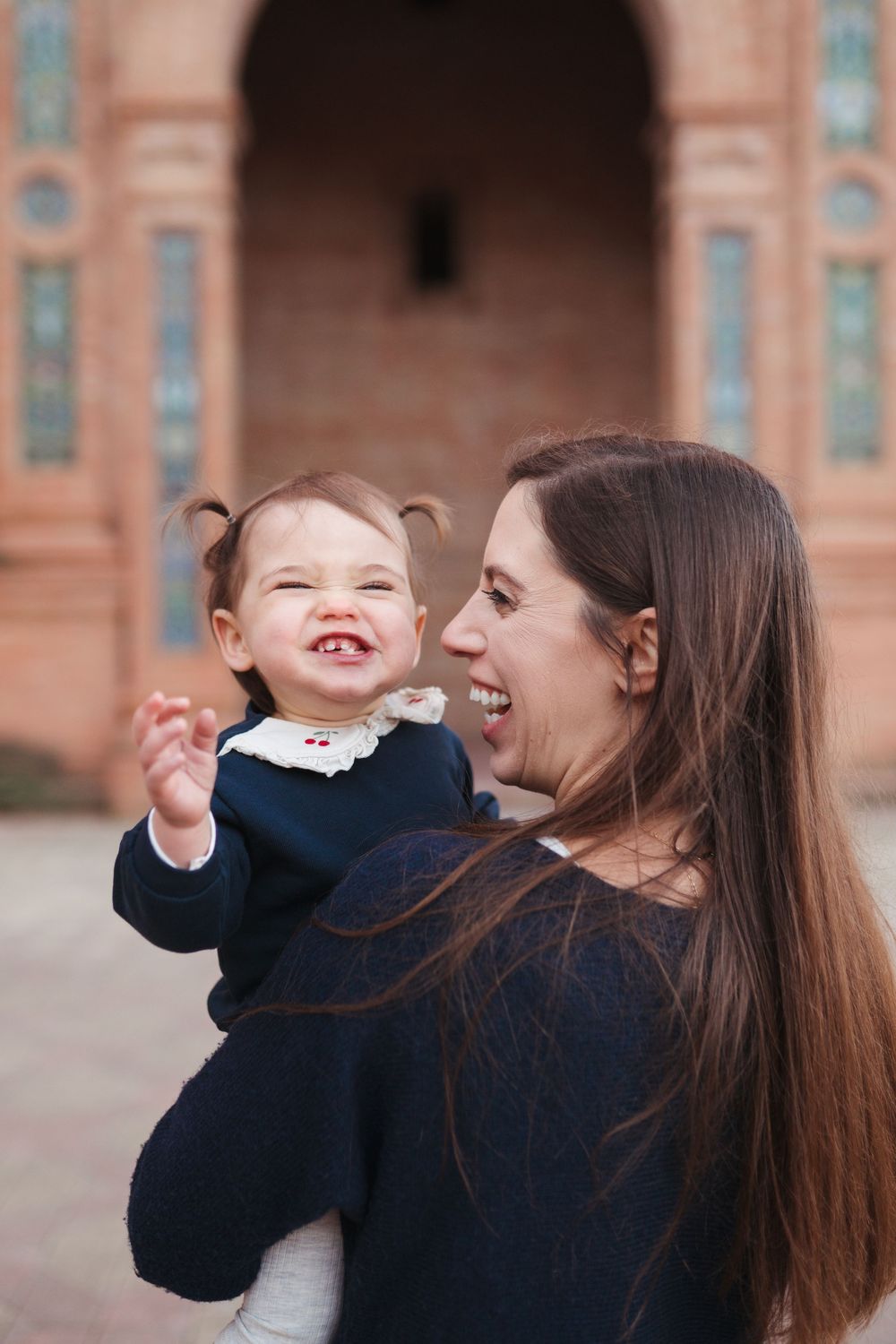 Candid moment of joy shared at the historic Plaza de España in Seville.