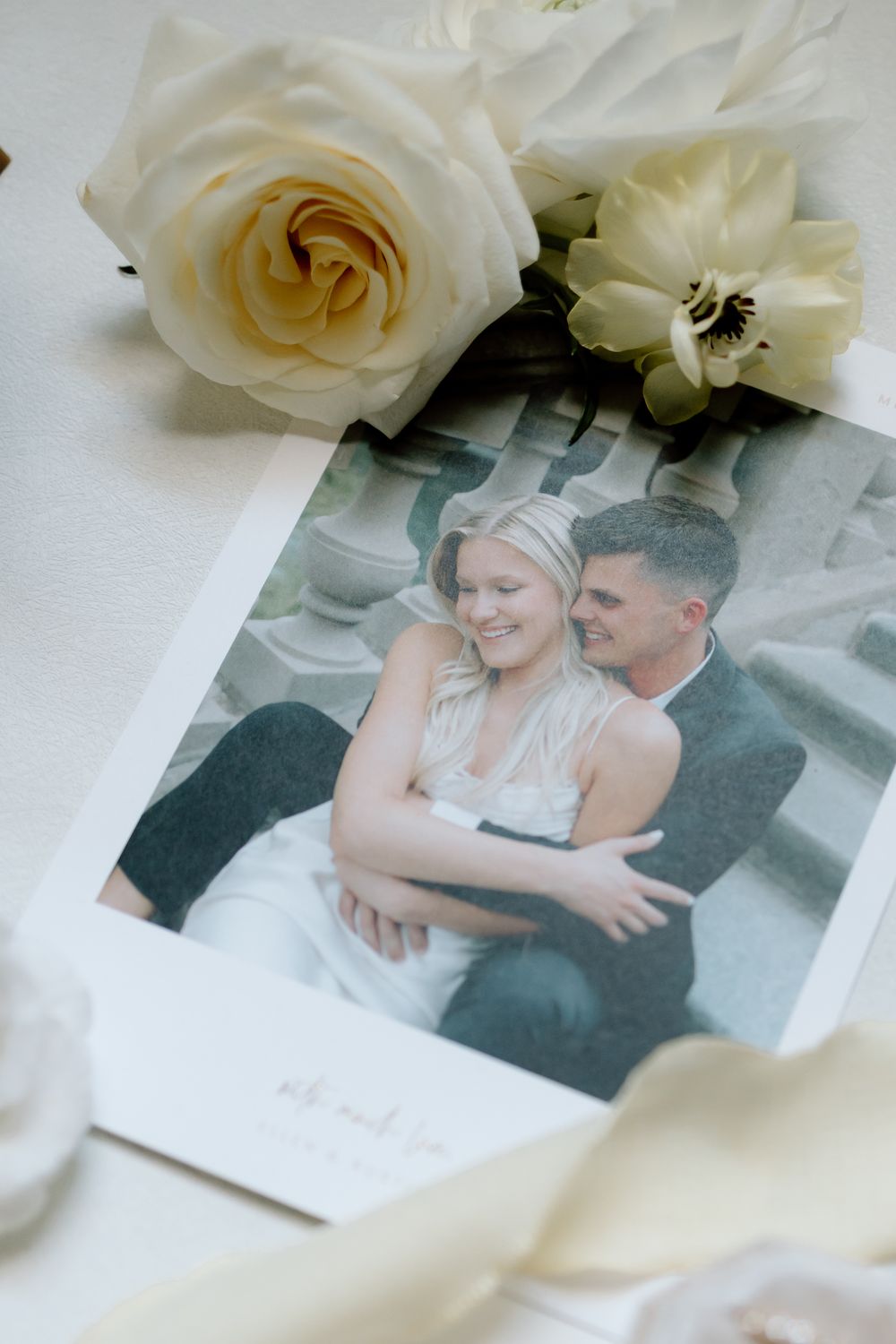 Wedding photograph displayed with white roses as decoration.
