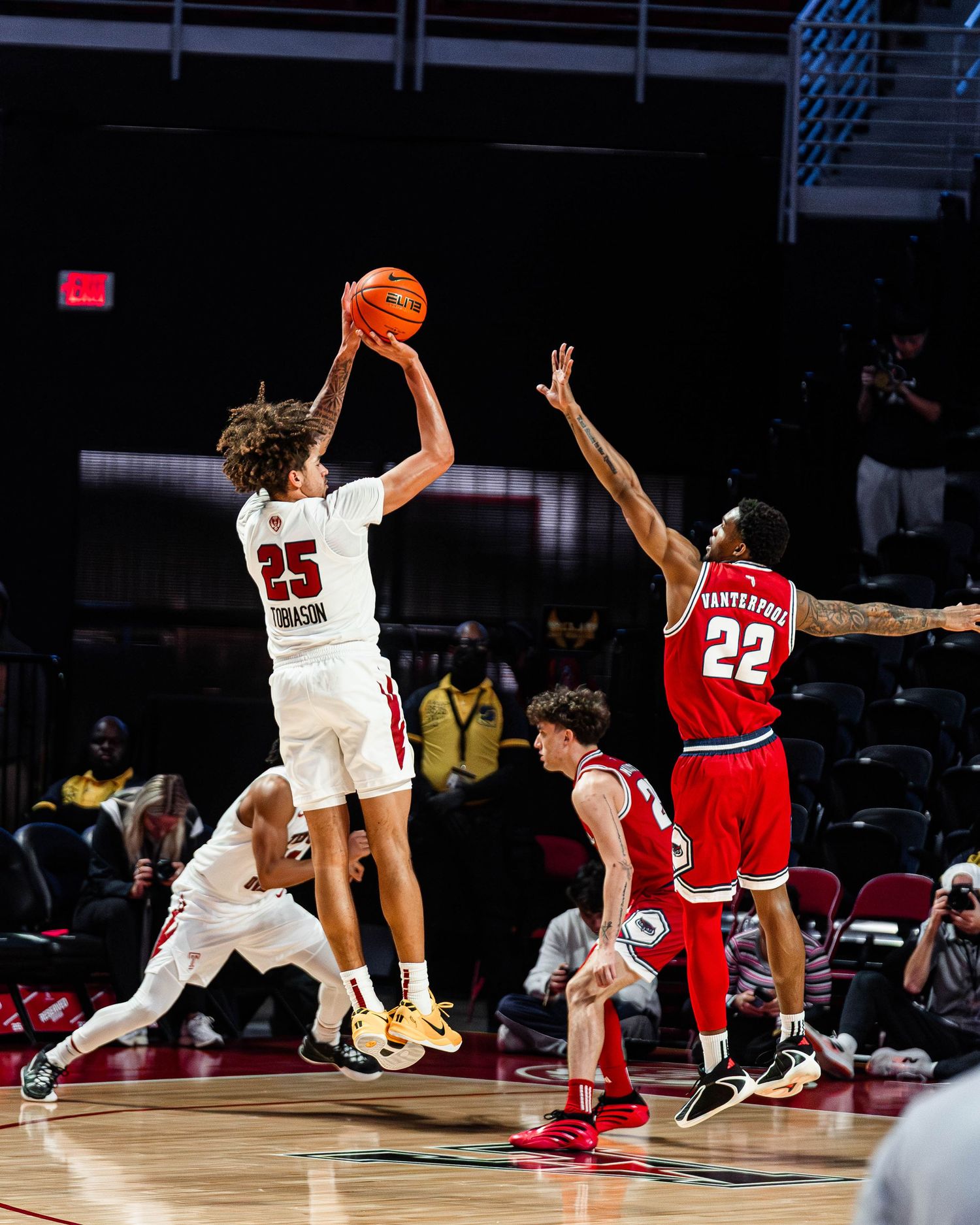 Basketball players leap and stretch in a dynamic sequence showing athletic moves during an intense game.