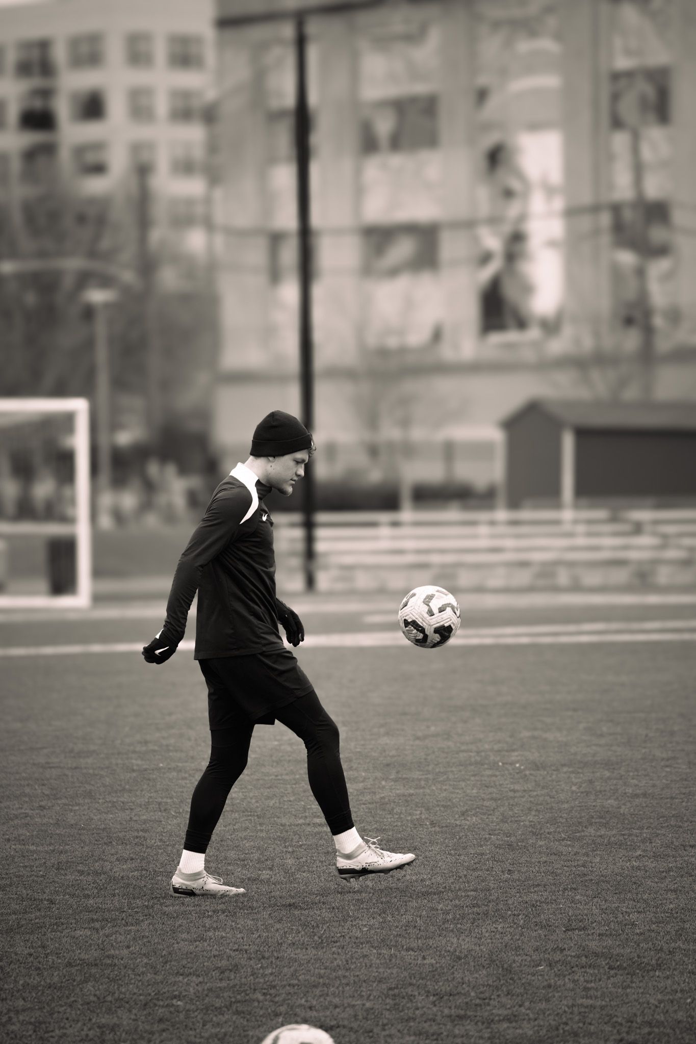 A black and white photo sequence shows a soccer player practicing ball control moves on an outdoor field.