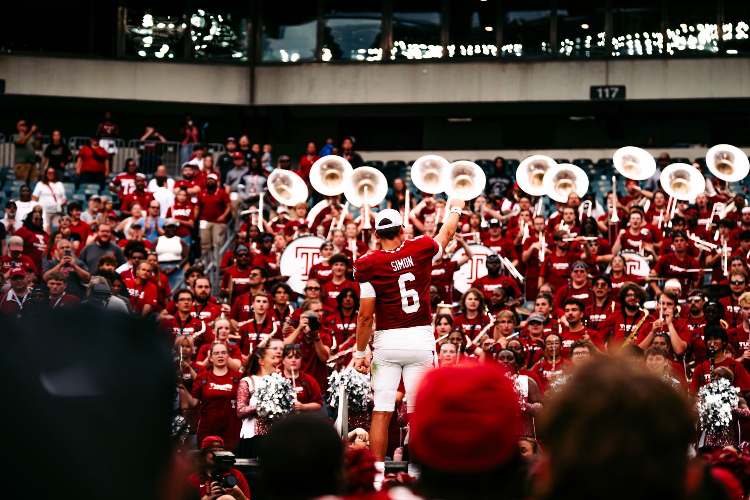 A series of panoramic crowd shots showing fans in red and white colors at a sporting event.