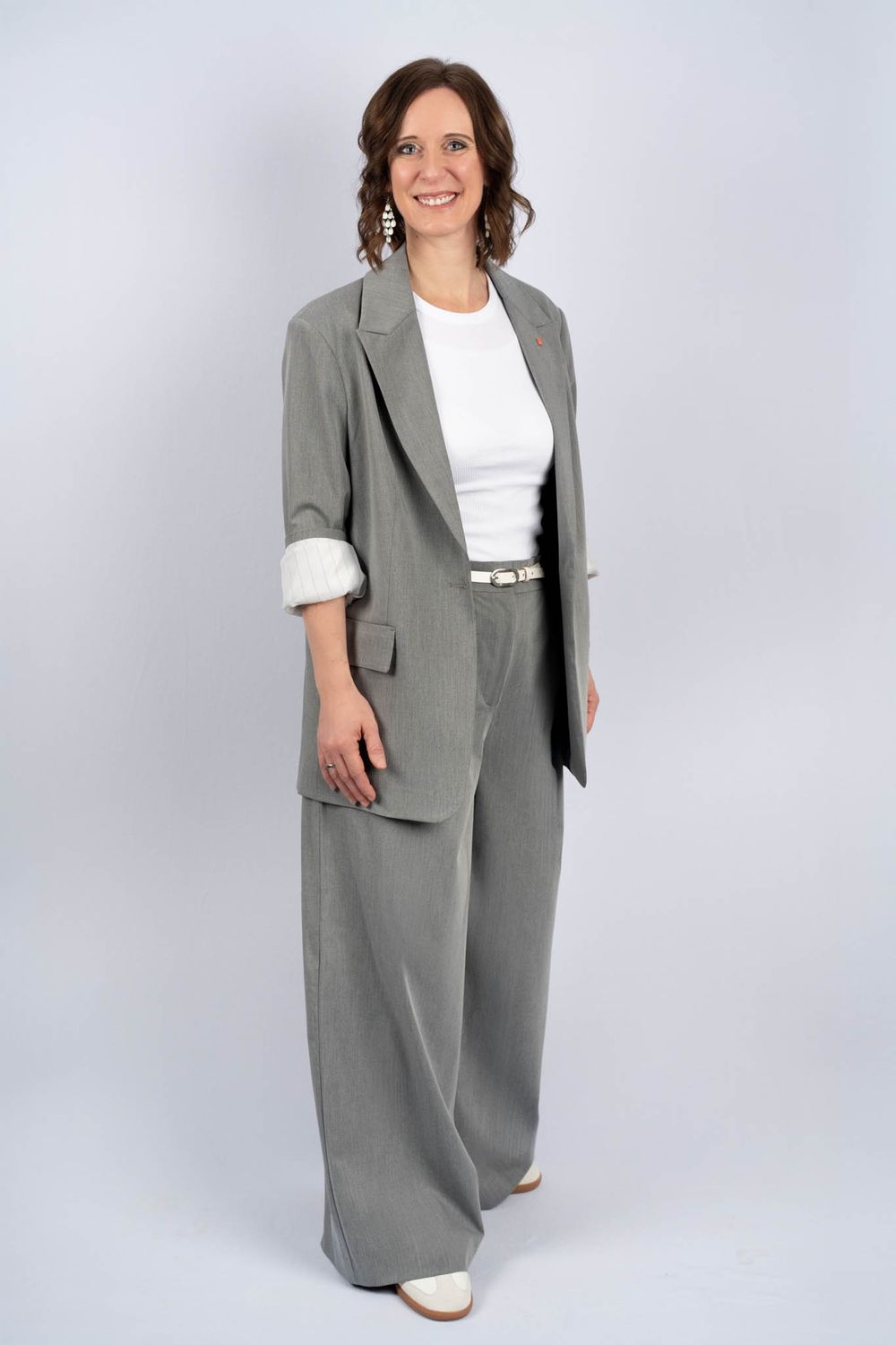 Professional gray linen suit with wide-leg pants and blazer paired with white top and sneakers shown from multiple angles.