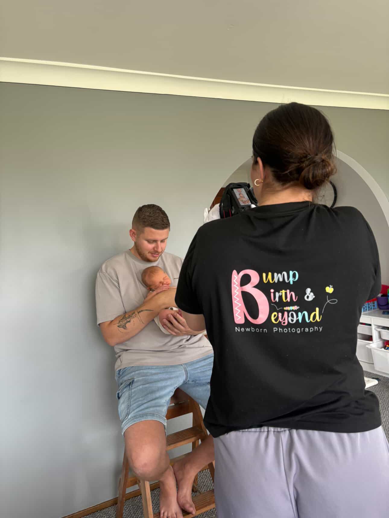 Professional newborn photographer at Bump Birth and Beyond capturing newborn baby and his dad in their own home in Penrith.