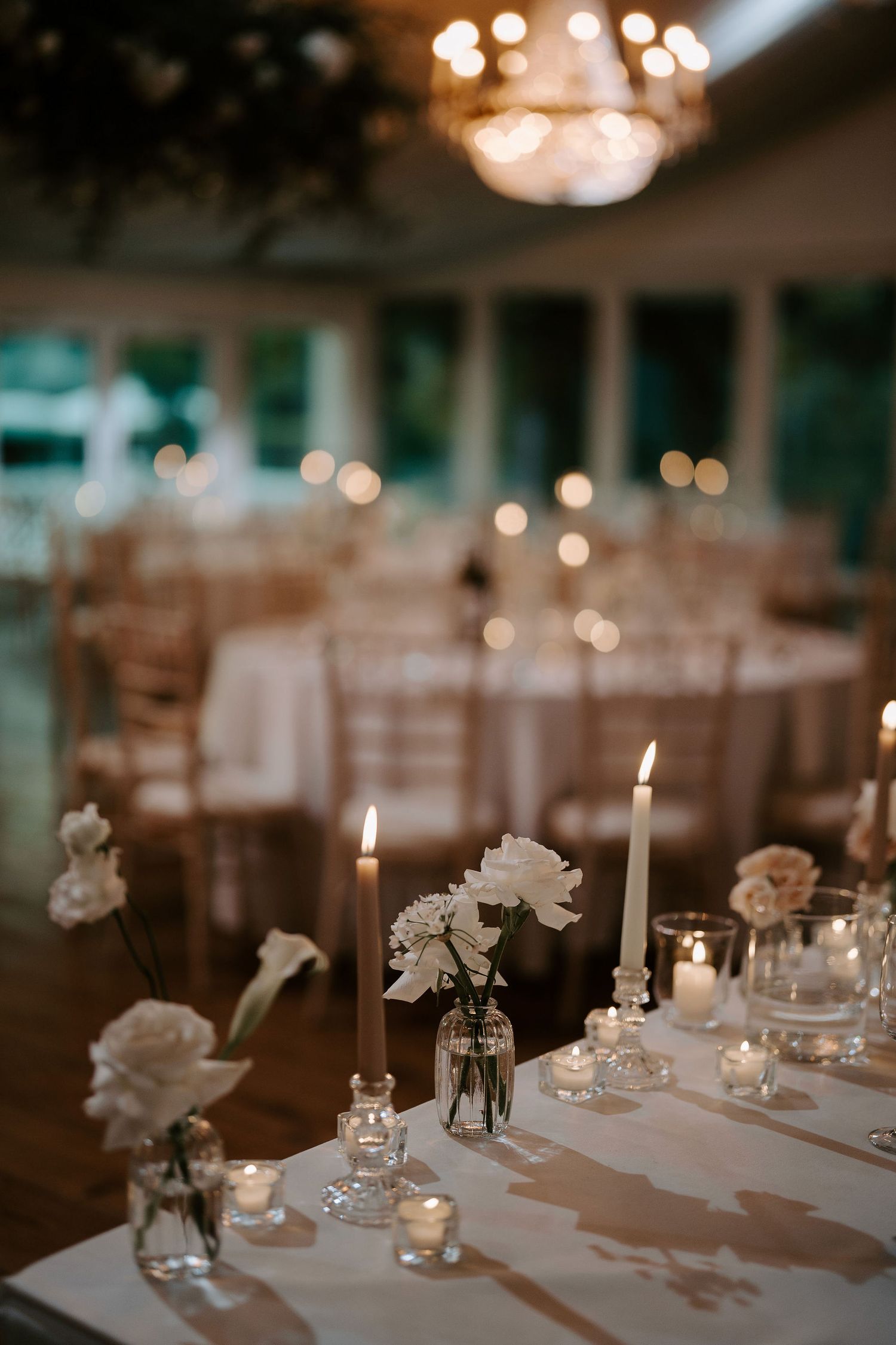 candles and floral arrangements on table in marquee at Iscoyd park