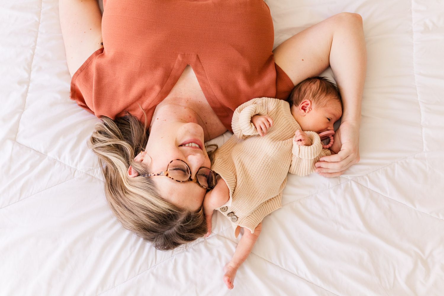 Richmond, Virginia newborn photography session capturing mom snuggling with her new baby girl from a birds eye view.