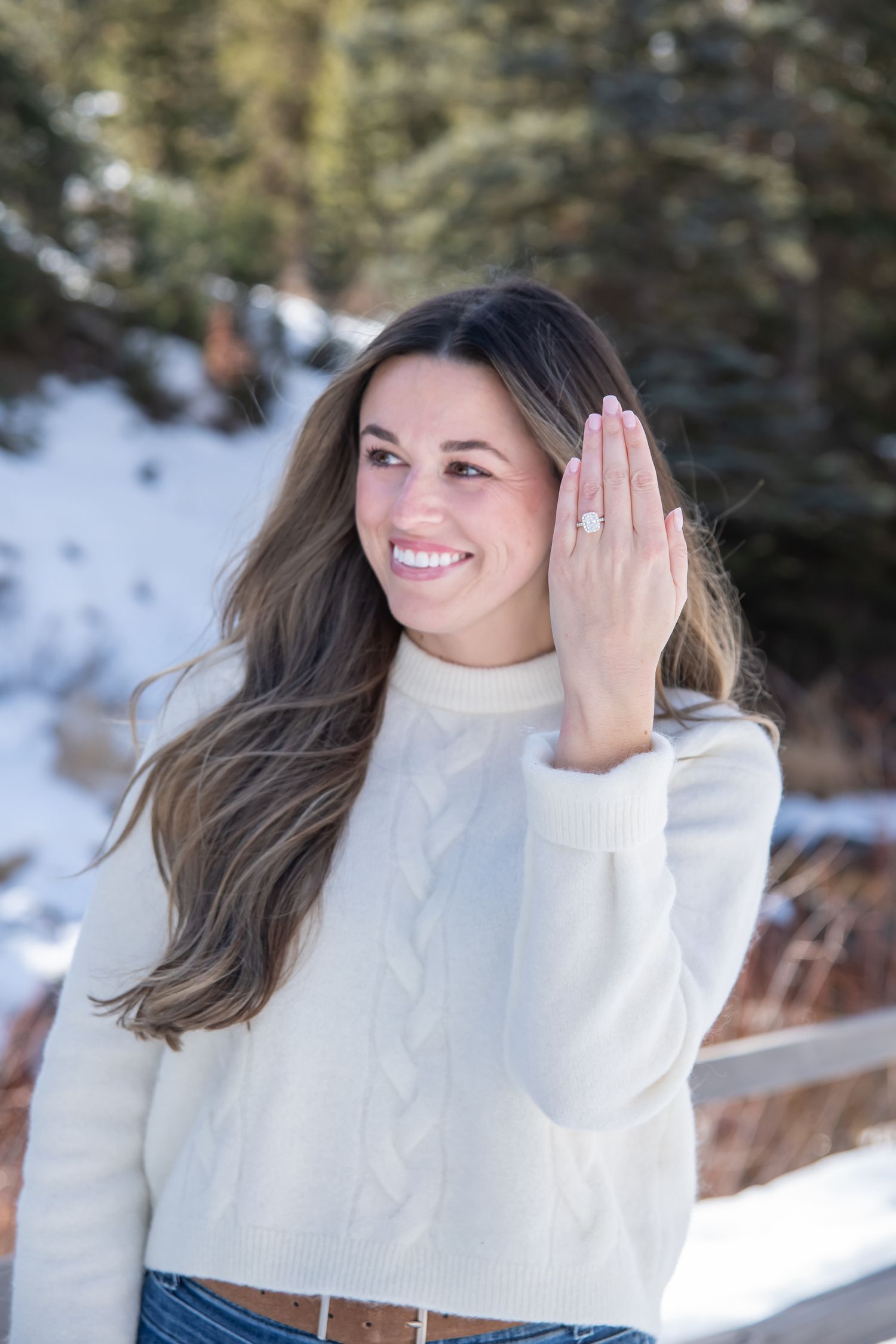 Fashionable woman shows off her engagement ring after a cute winter proposal in Vail Colorado