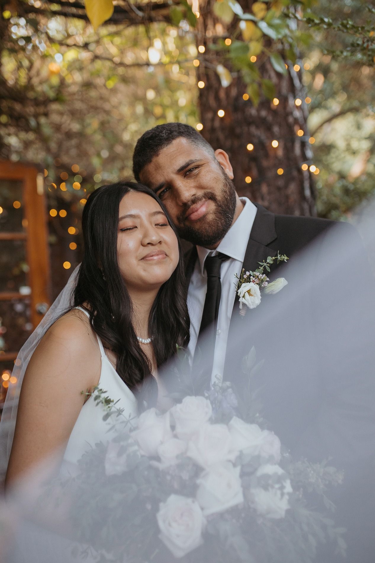 Romantic wedding couple shares intimate moments in a series of candid photos with soft lighting and floral details Inn of the Seventh Ray.