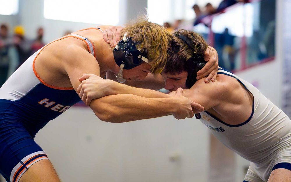 Close-up action shot of Christian Burd grappling with his opponent during Hershey Wrestling’s milestone victory.