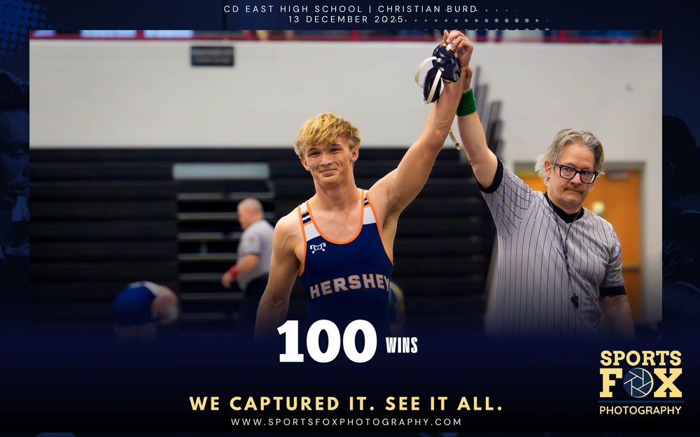 Christian Burd of Hershey Wrestling celebrates his 100th career win with referee raising his hand at Central Dauphin East Tournament.