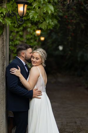 Bride and groom embracing at wedding venue in Gauteng with natural, romantic style