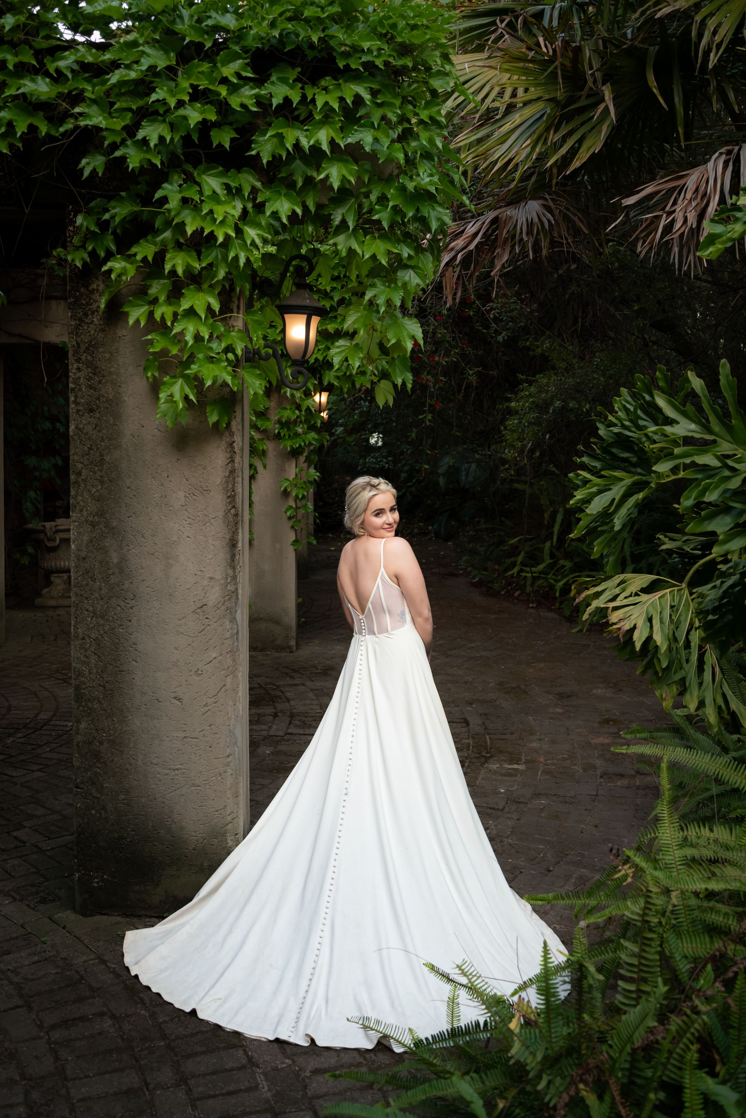 Bride walking away in wedding dress at venue in Gauteng with natural, elegant style