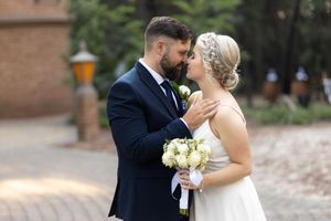 Bride and groom embracing during wedding portraits at venue in Gauteng with natural, romantic style