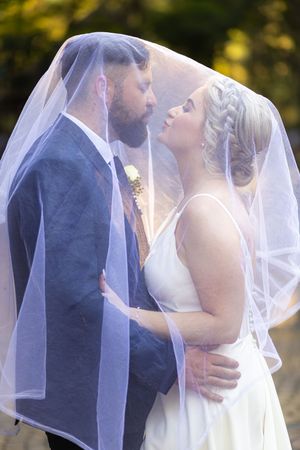 Bride and groom under veil during wedding portraits in Gauteng with natural, romantic style