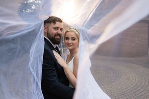 Bride and groom under veil during wedding portraits in Gauteng with soft, natural light