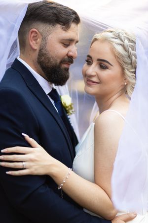 Bride and groom embracing under veil during wedding portraits in Gauteng with natural, romantic style