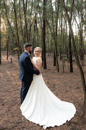 Bride and groom standing in forest during wedding portraits in Gauteng with natural, relaxed style