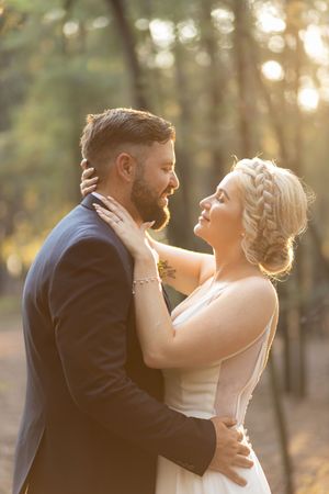 Bride and groom embracing in golden light during wedding portraits in Gauteng