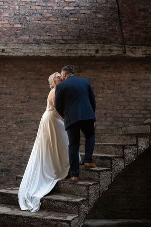 Bride and groom walking up stairs during wedding portraits in Gauteng with natural, elegant style