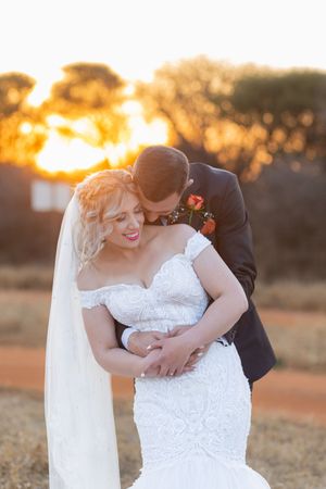 Bride and groom embracing at sunset during wedding in Gauteng with natural, romantic style