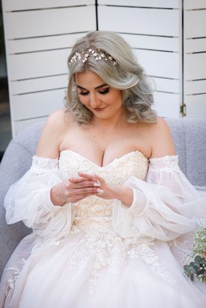 Bride looking at wedding ring during wedding preparation in Centurion with natural, elegant bridal styling