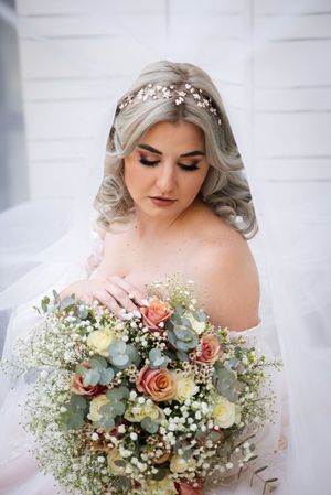 Bride portrait holding bouquet during wedding preparation in Gauteng with natural, elegant style