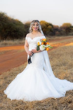 Bride standing with bouquet during wedding portraits in Gauteng with natural, relaxed style