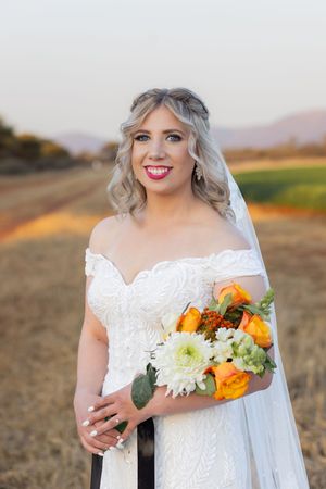 Bride portrait holding bouquet during wedding in Gauteng with natural, relaxed style