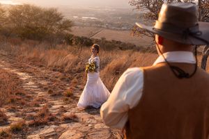 Bride walking toward groom during sunset wedding portraits in Gauteng