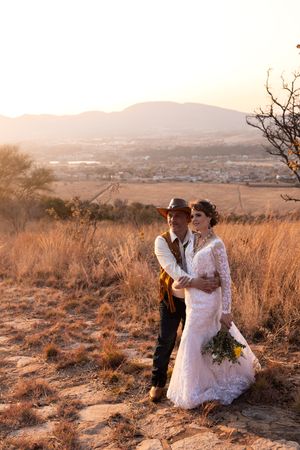 Bride and groom walking together during sunset wedding portraits in Gauteng