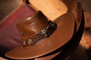 Groom detail with leather hat during wedding preparation in Gauteng