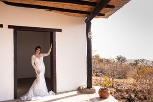 Bride standing at wedding venue doorway during preparation in Gauteng