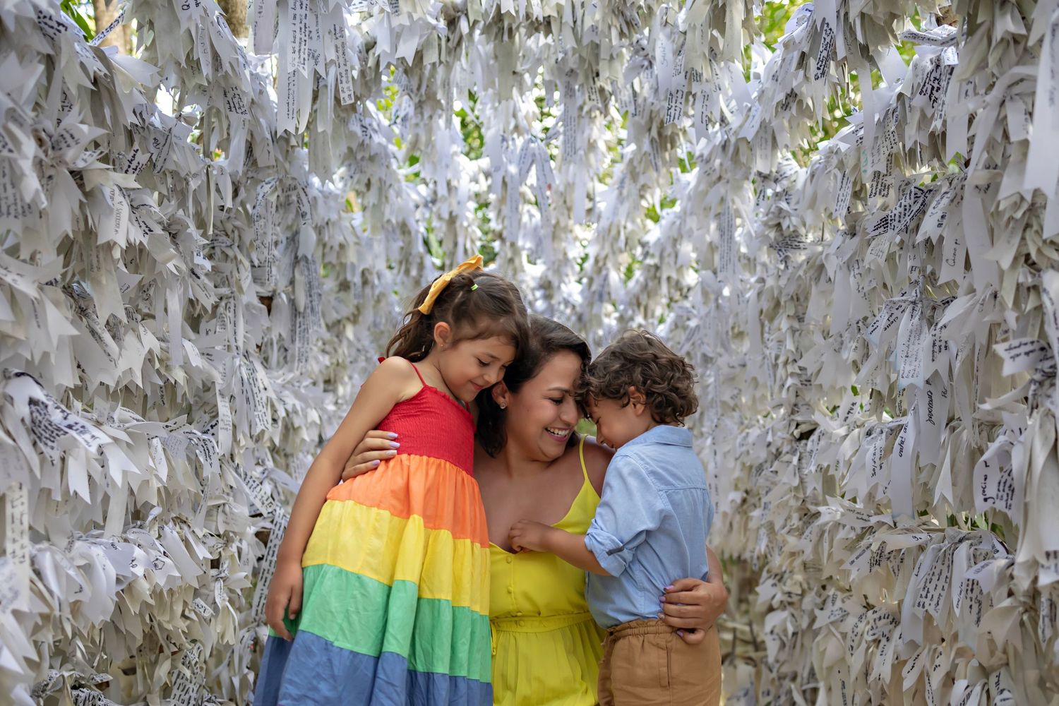 A heartwarming family moment against a backdrop of hanging white ribbons.