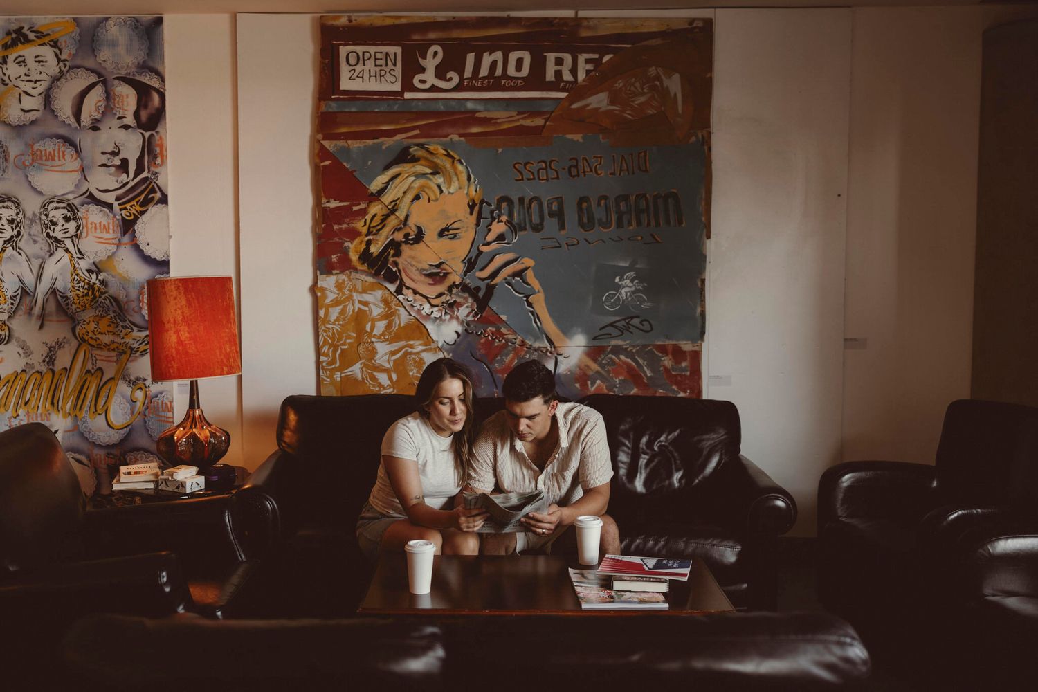 couple hang out at a moody, alternative cafe, at hotel wolfe island, stone's throw cafe.