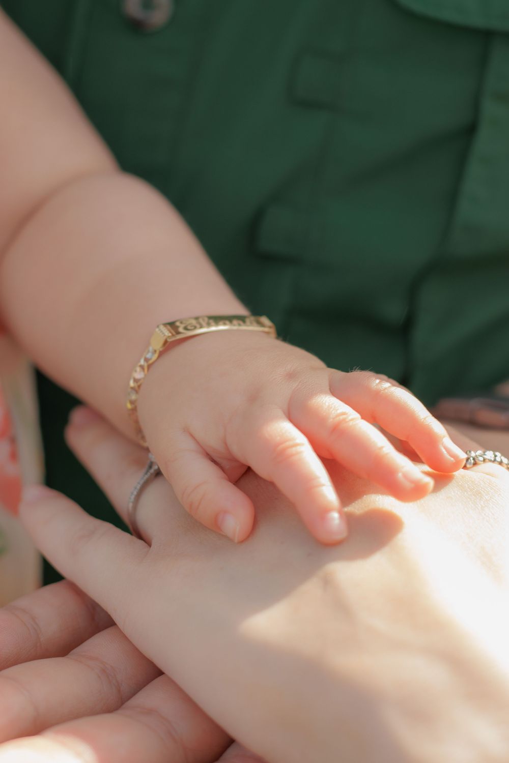 The image shows a close-up view of a person's hands, with a bracelet or jewelry visible on the wrist.