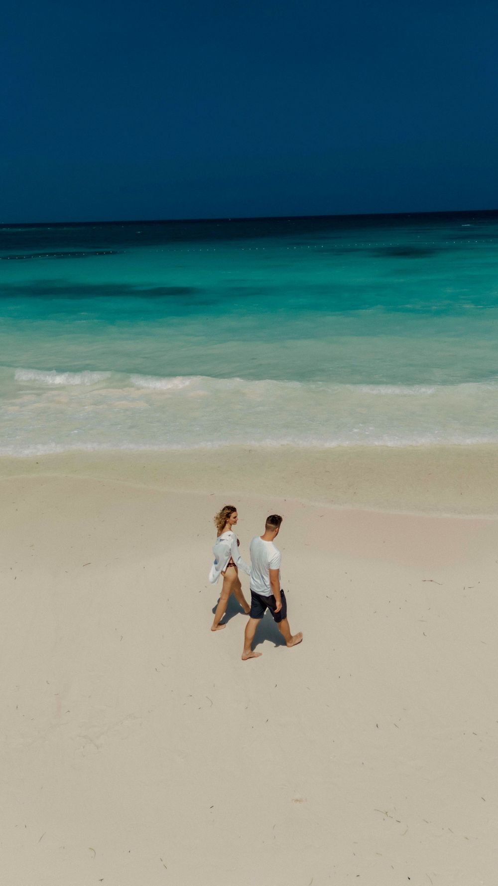 Engagement photos captured in turquoise Zanzibar waters